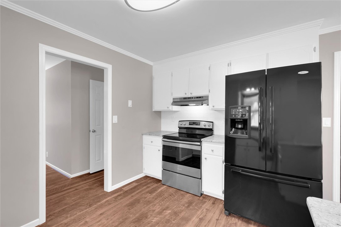 519 Hillandale Road Liberty, SC 29657 - Photo 11 of 24 Rich wood-toned flooring pairs beautifully with crisp crown molding in this refreshed cooking space.