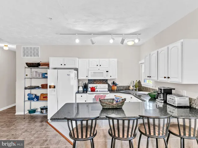 a living room with furniture and a lamp