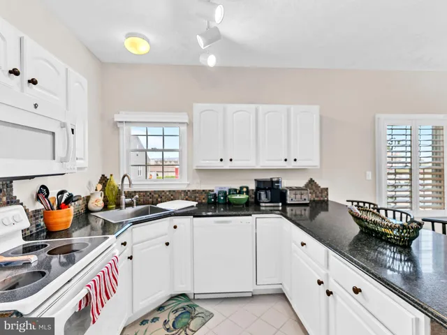 a living room with furniture and a flat screen tv with a large window