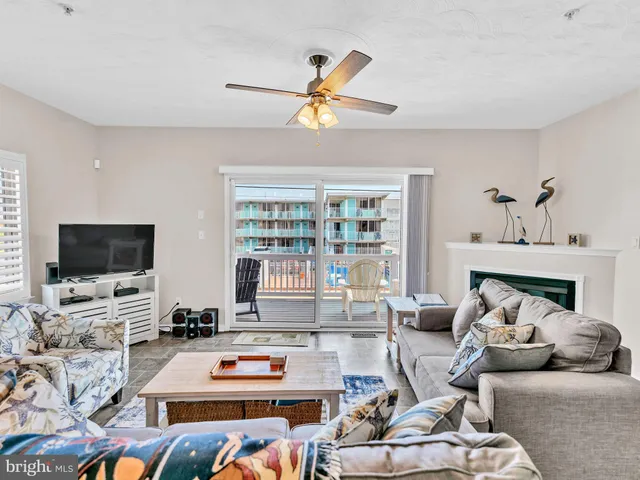 a bedroom with bed and ceiling fan