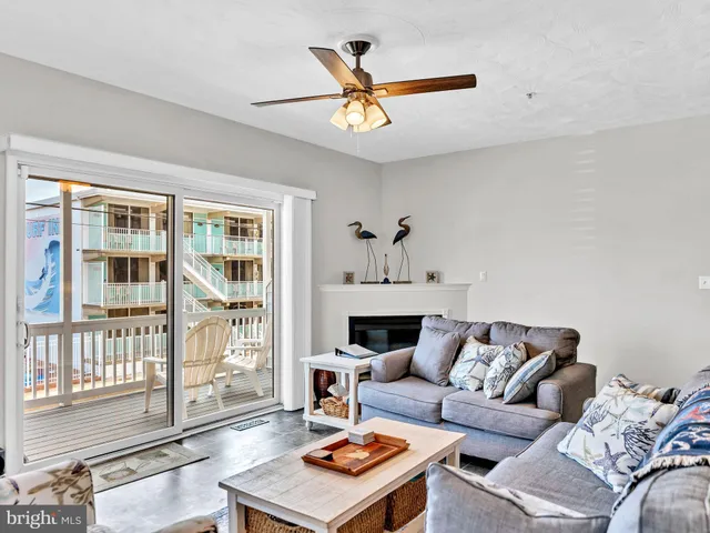 a view of a balcony with chairs and wooden fence