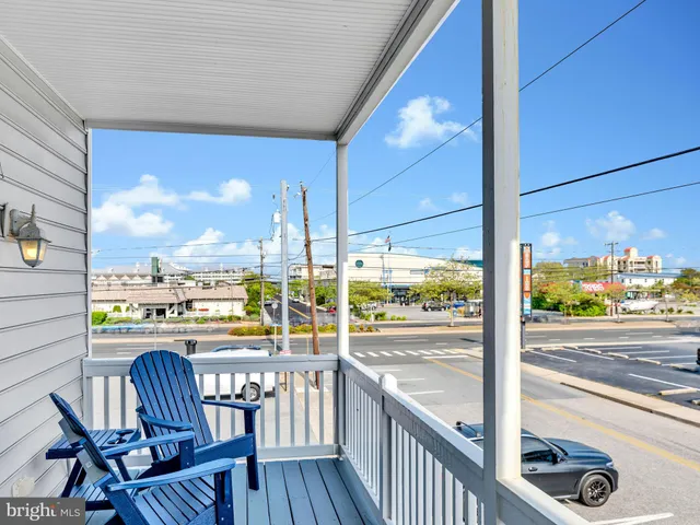 a bedroom with a bed and a flat tv screen on dresser