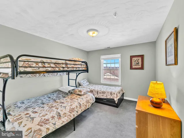 a kitchen with granite countertop a sink a stove and a wooden cabinets