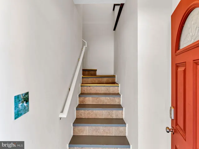 a kitchen with stainless steel appliances granite countertop a table chairs sink and white cabinets