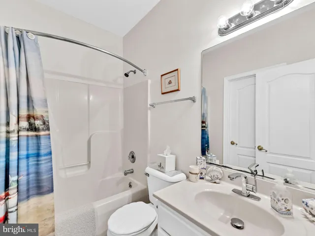 a front view of a building with a garden and plants