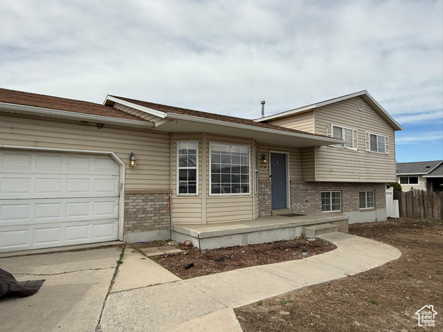 210 South 650 West Payson, UT 84651 - Photo 1 of 1 Split level home with brick siding, concrete driveway, an attached garage, and fence