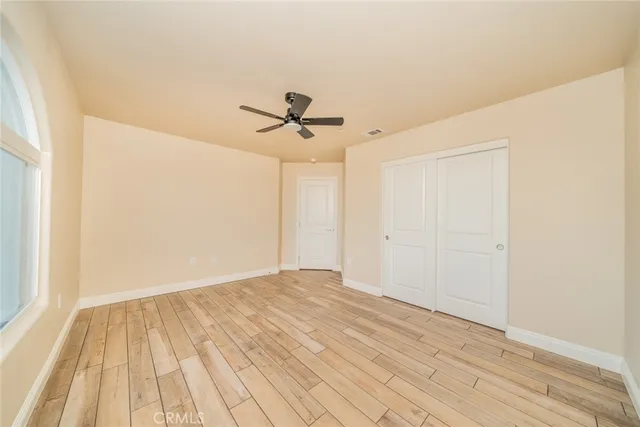 a view of a kitchen with wooden floor and cabinets