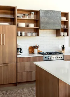 a kitchen with stainless steel appliances a stove a sink and a refrigerator