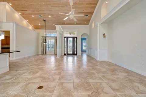 a view of a hallway with dining area and chandelier