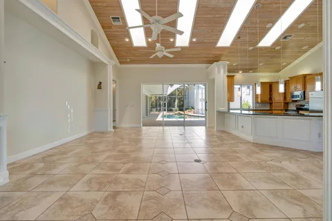 a large kitchen with kitchen island granite countertop a large counter top and stainless steel appliances
