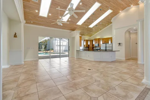 a large kitchen with granite countertop a sink and cabinets