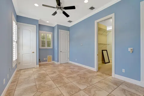 a room with lots of windows and potted plants