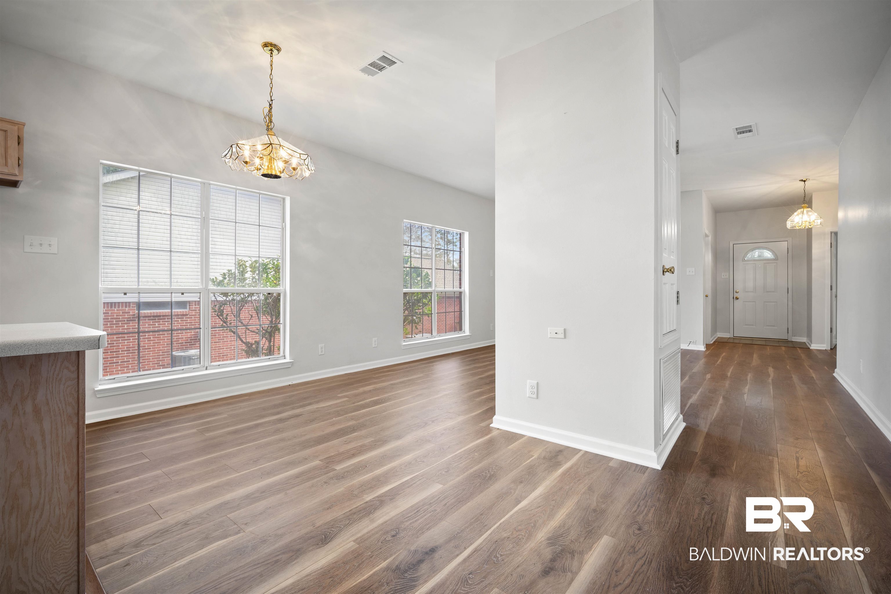 250 North Spring Lake Drive Mobile, AL 36695 - Photo 16 of 29 Unfurnished dining area with a chandelier and dark wood-style floors
