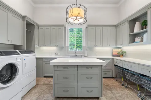 a kitchen with a stove top oven sink and cabinets