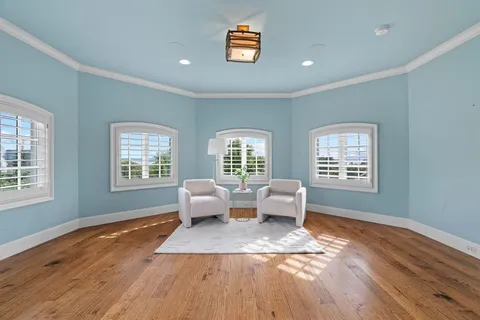 a living room with couches bookshelf and a window