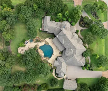 an aerial view of a house with outdoor space and lake view