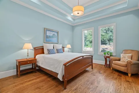 a bed room with a bed and a chair