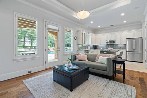 a living room with furniture wooden floor and a chandelier