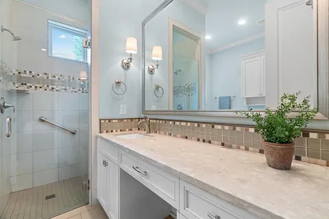 a bathroom with a shower sink and mirror