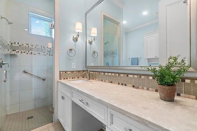 a bathroom with a shower sink and mirror
