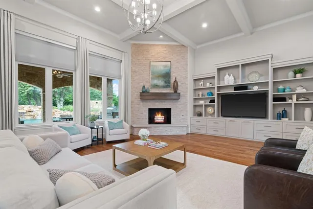 a living room with furniture fireplace and flat screen tv