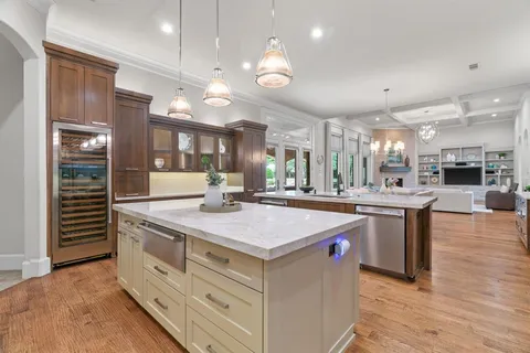a kitchen with stainless steel appliances granite countertop a sink a counter space and cabinets