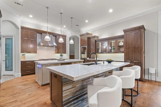 a large kitchen with a table and chairs