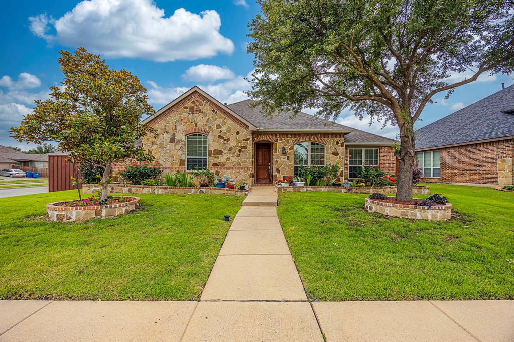 7306 Statford Drive Rowlett, TX 75089 - Photo 1 of 1 a front view of a house with garden and tree