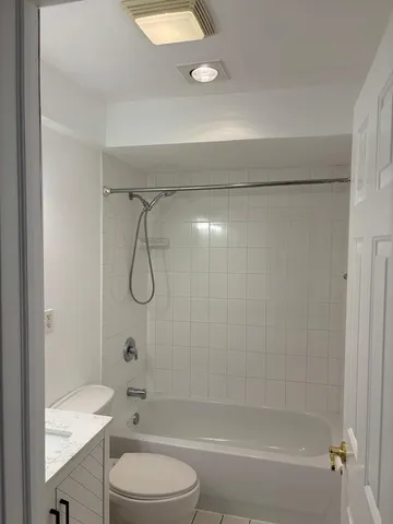 a bathroom with a shower a toilet and a sink