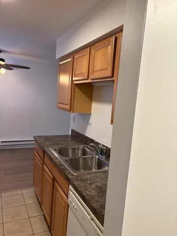 a utility room with sink and washing machine