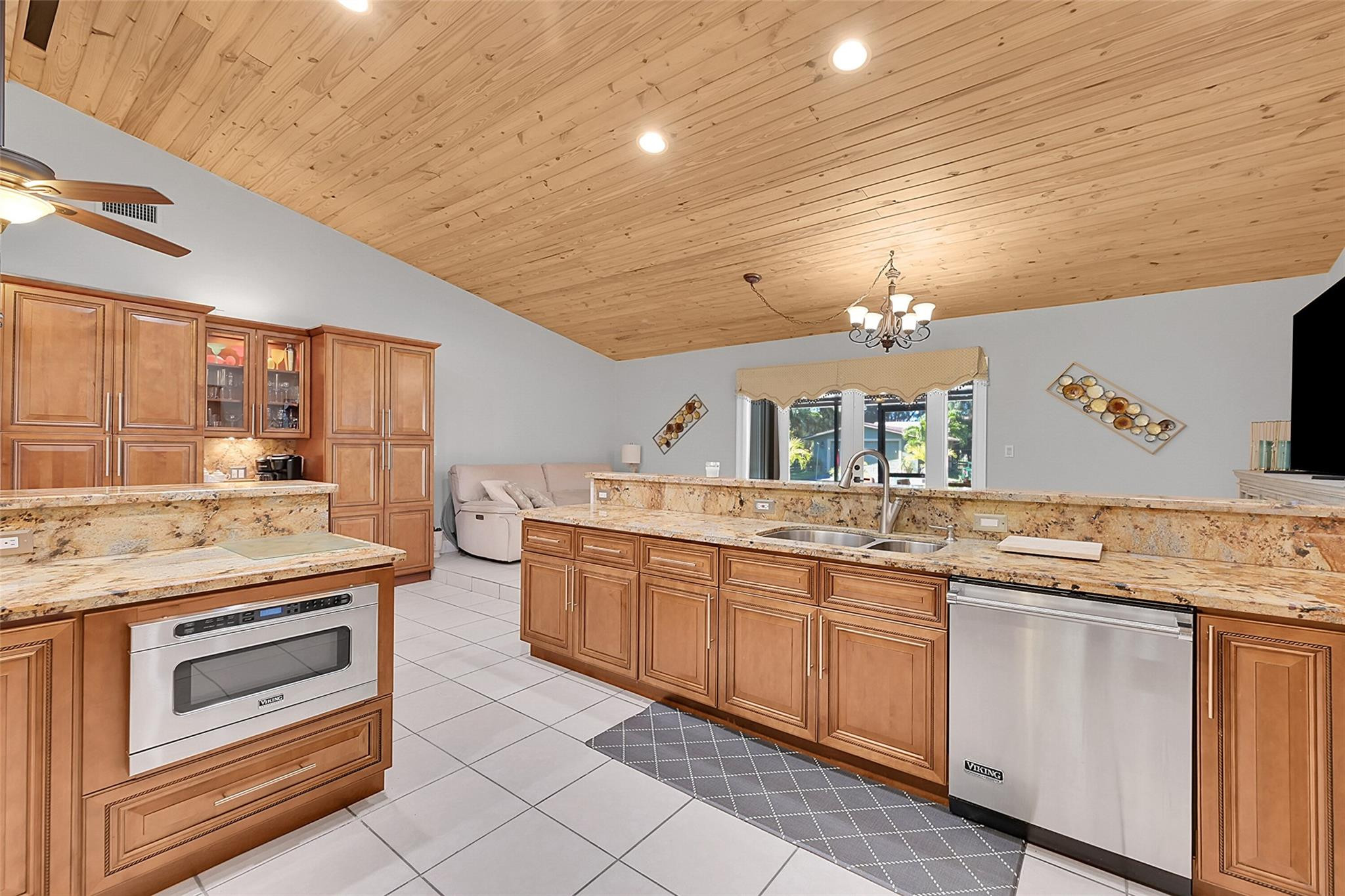 a kitchen with granite countertop a sink and cabinets