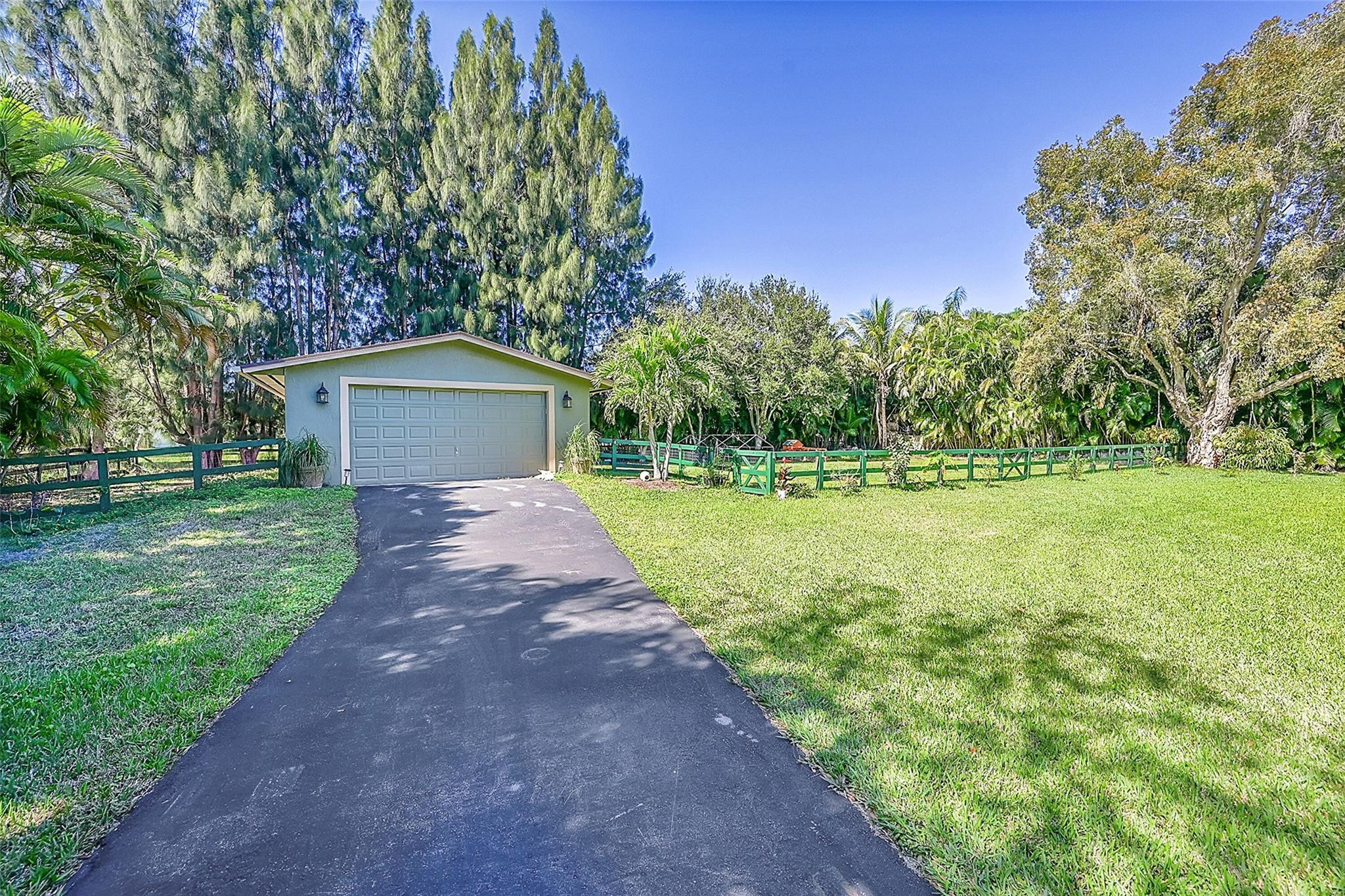Undisclosed Address Southwest Ranches, FL 33331 - Photo 11 of 24 a front view of a house with garden