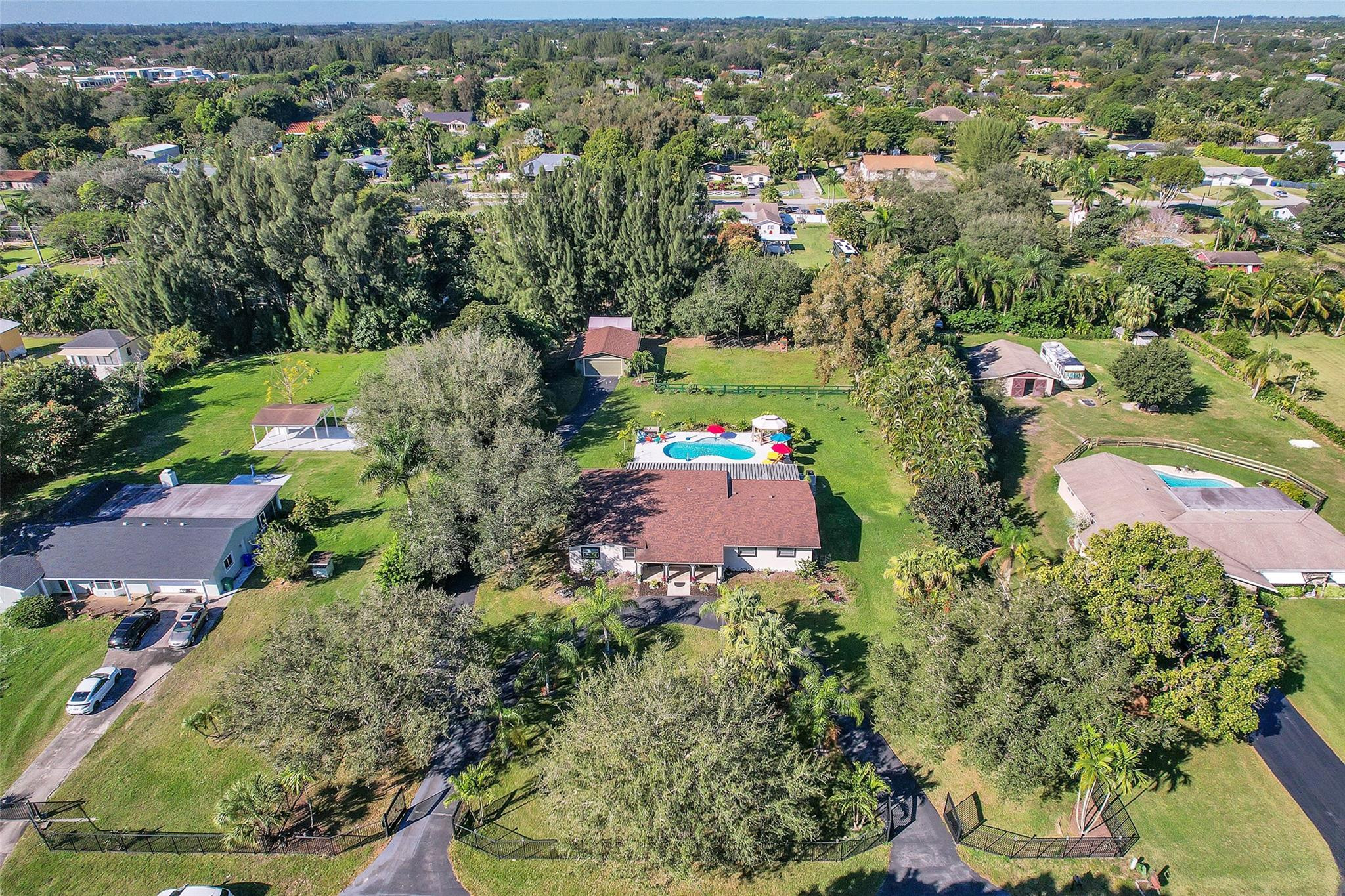 Undisclosed Address Southwest Ranches, FL 33331 - Photo 16 of 24 an aerial view of a houses with a yard