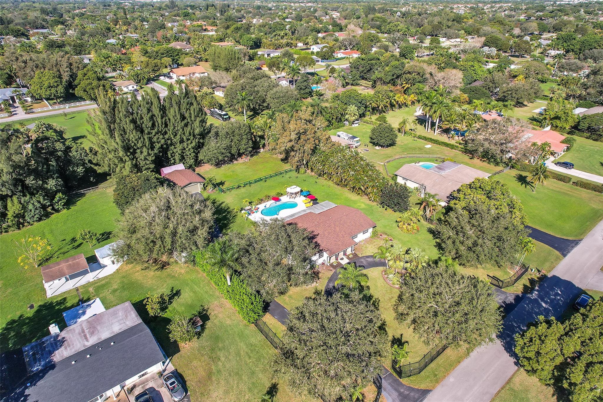 Undisclosed Address Southwest Ranches, FL 33331 - Photo 22 of 24 an aerial view of a house with a yard