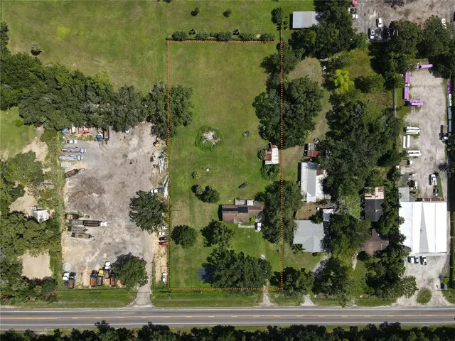 an aerial view of a houses with yard