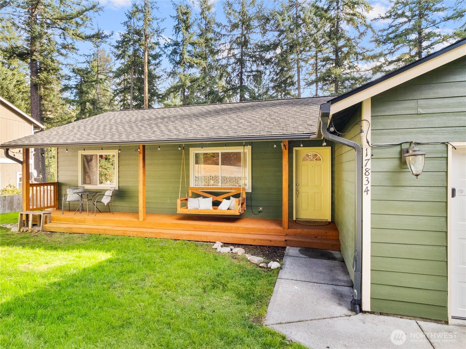 a front view of a house with a yard glass top table and chairs