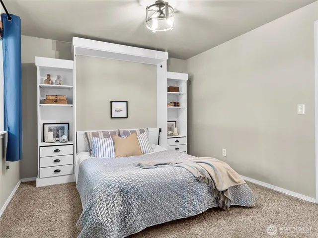 a bedroom with a bed and a chandelier