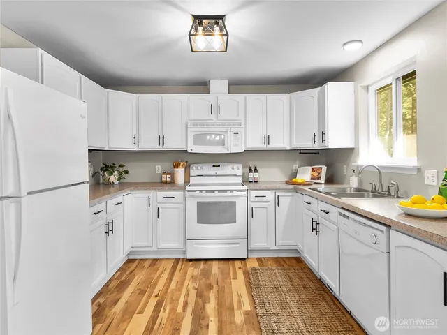 a kitchen with a white cabinets and white appliances