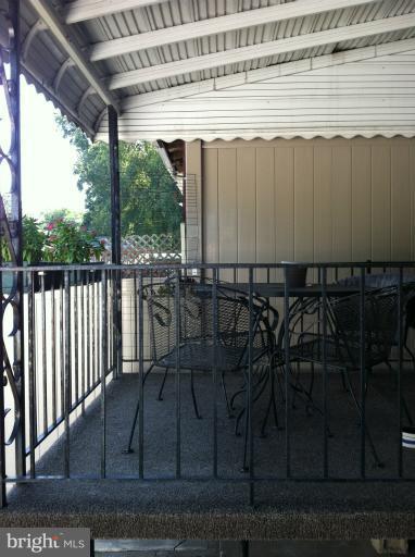 174 West Meadow Road Baltimore, MD 21225 - Photo 14 of 18 a view of a backyard with table and chairs with wooden floor and fence