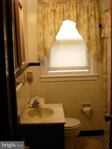 174 West Meadow Road Baltimore, MD 21225 - Photo 3 of 18 a bathroom with a sink and a toilet