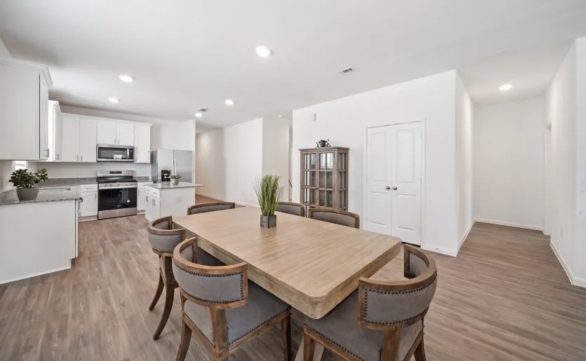 248 Seven Pines Willis, TX 77378 - Photo 4 of 17 a view of a dining room with furniture and wooden floor