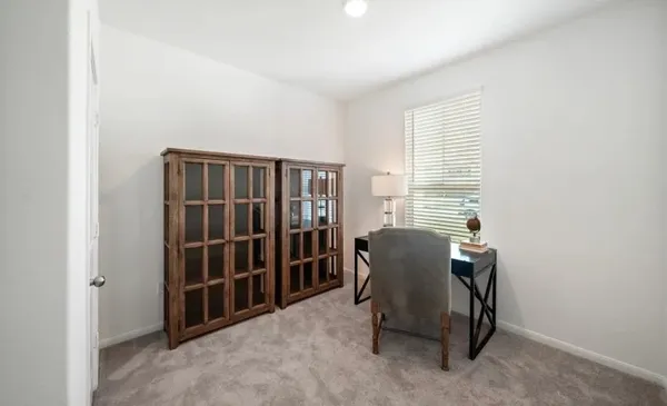 a view of a room with furniture and windows