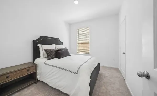 a bed room with a bed and a window