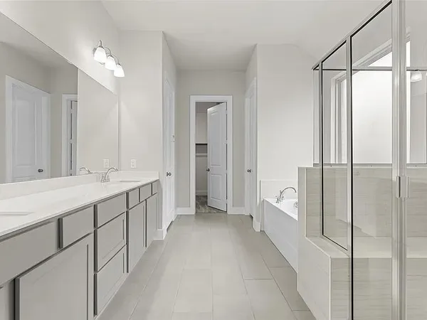 a bathroom with a double vanity sink and mirror
