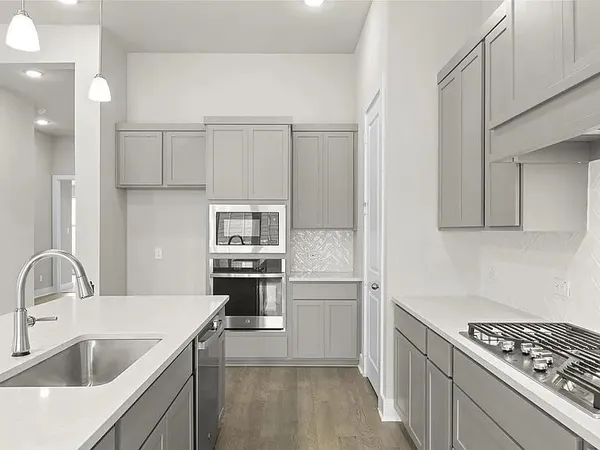 a kitchen with a sink stove and refrigerator