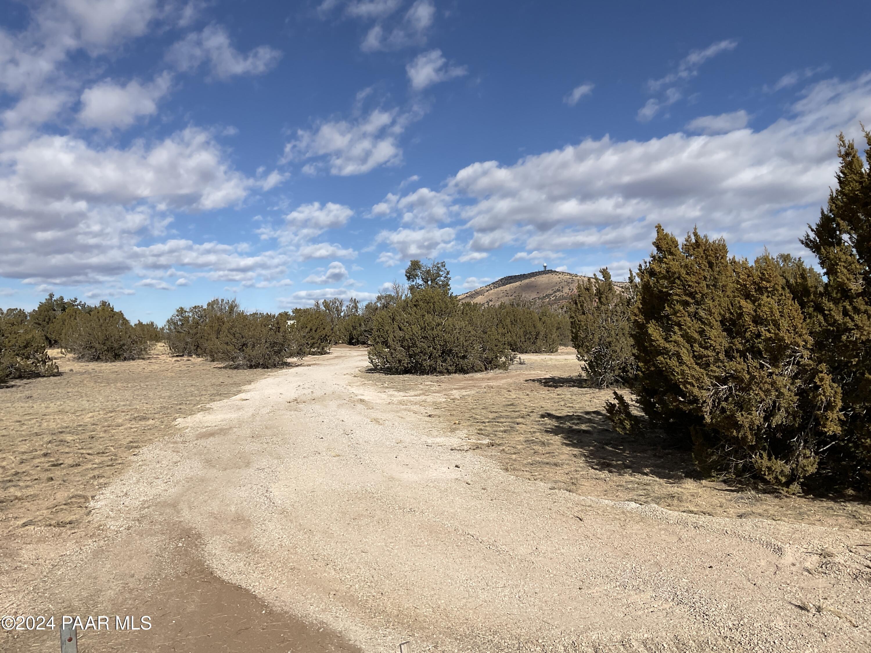 Lot 383 Fort Rock Road Seligman, AZ 86337 - Photo 4 of 16 a view of a yard covered with snow in the yard