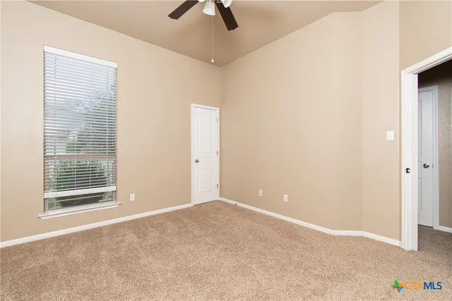 an empty room with windows and closet
