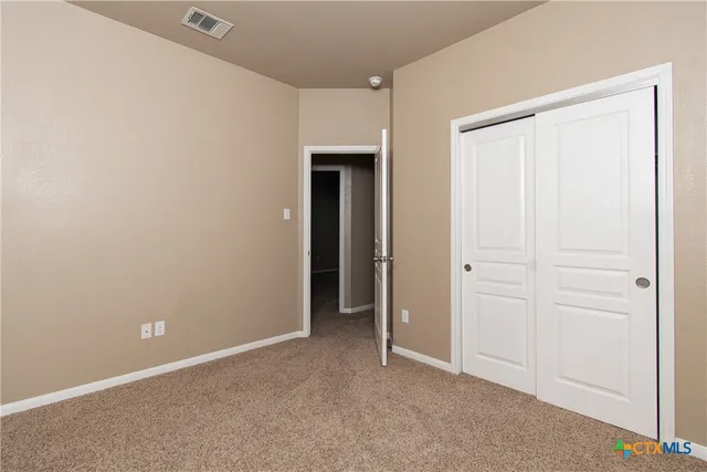 an empty room with closet area