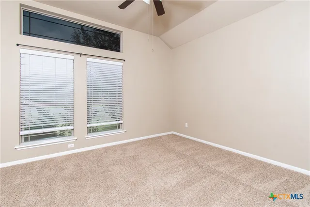 a view of an empty room with windows