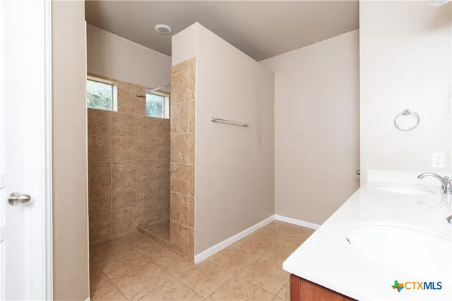 a bathroom with a tub sink and vanity
